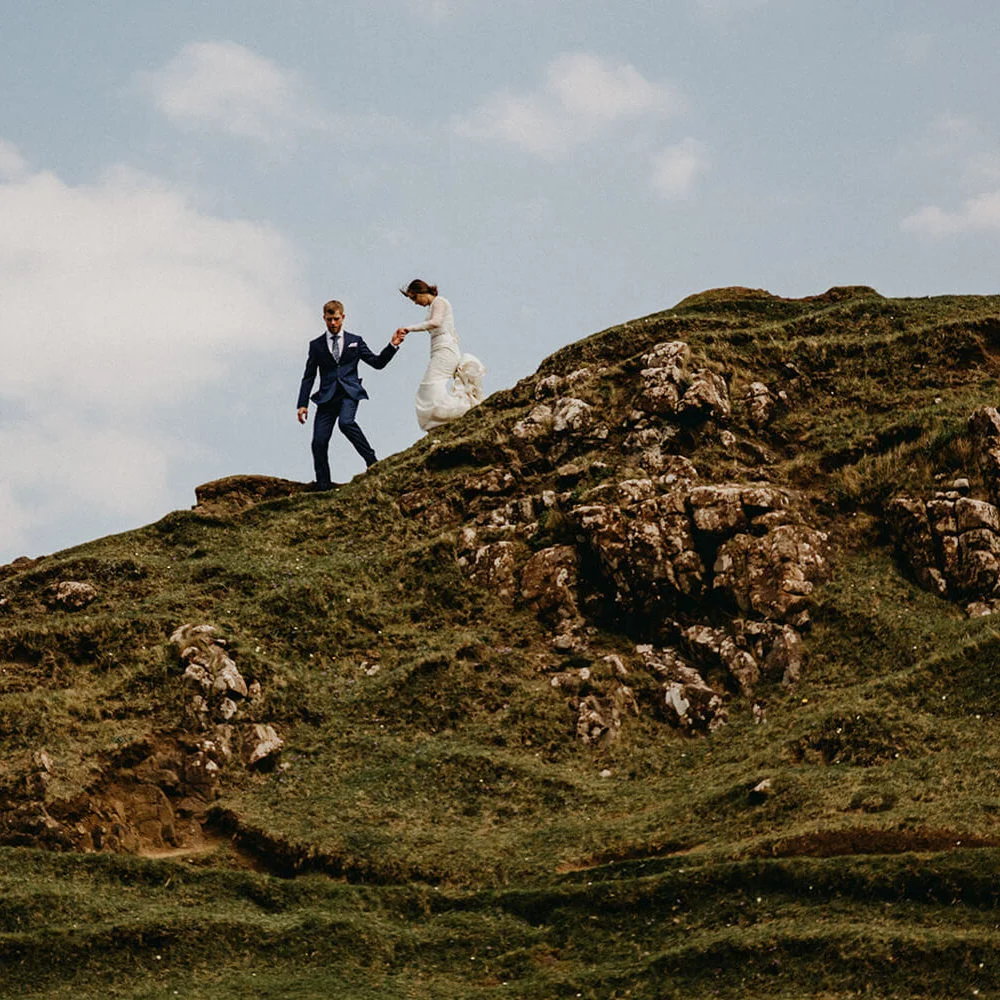 Scottish elopement planner scotland landscape micro wedding bride groom portraits walking across mountain isle of skye