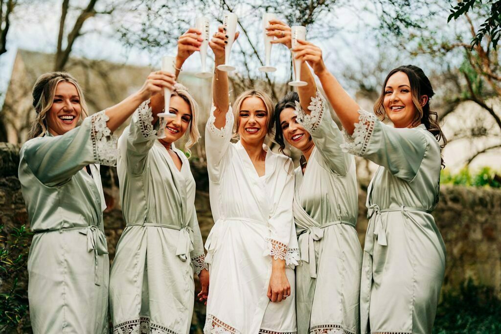 colourful forgans micro wedding outdoor champagne celebrations bride bridesmaids matching robes fluffy slippers